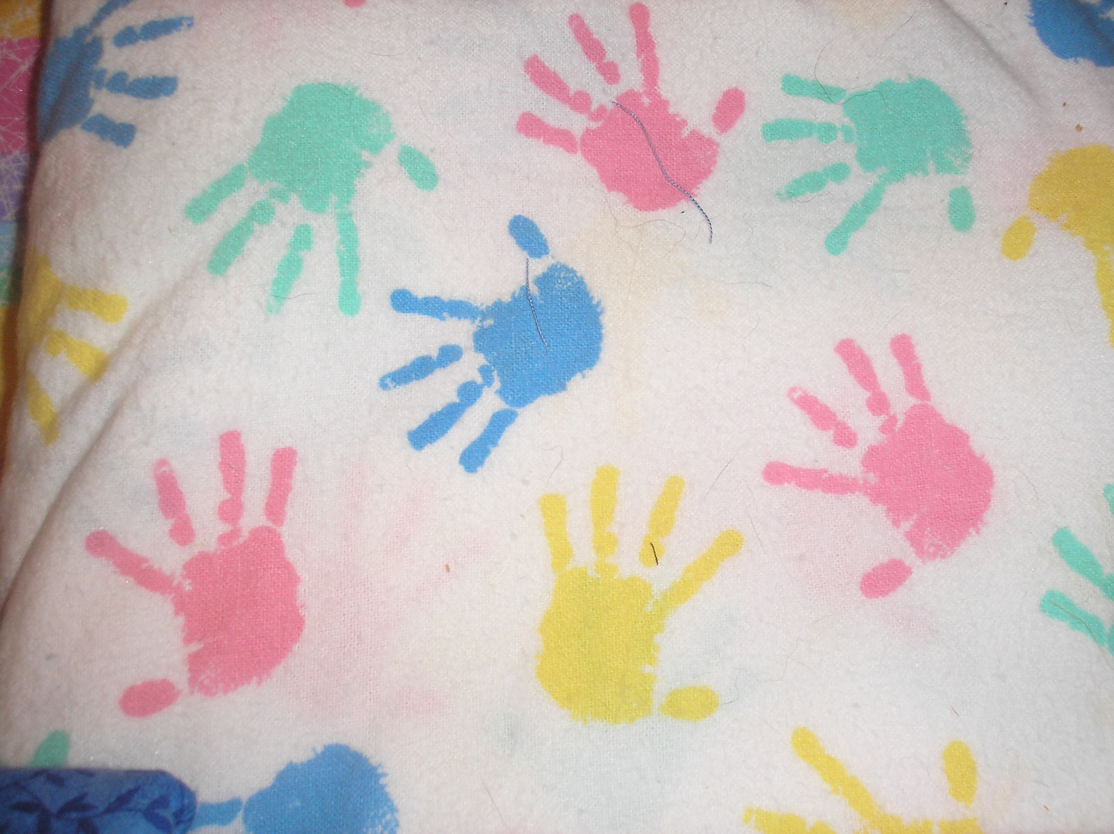 Pastel hand-prints on white background